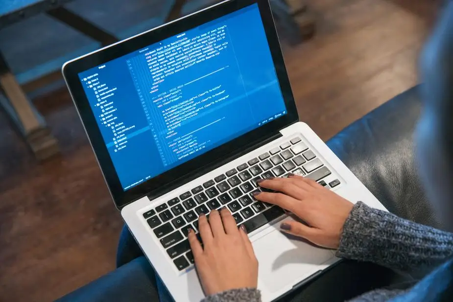 hands typing code on laptop.jpg